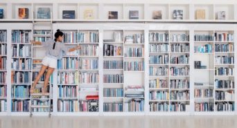 Empleada de una librería organizando los libros en las estanterías.