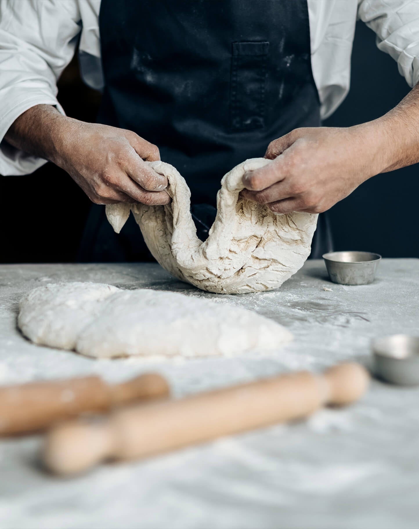 A baker rolls out dough