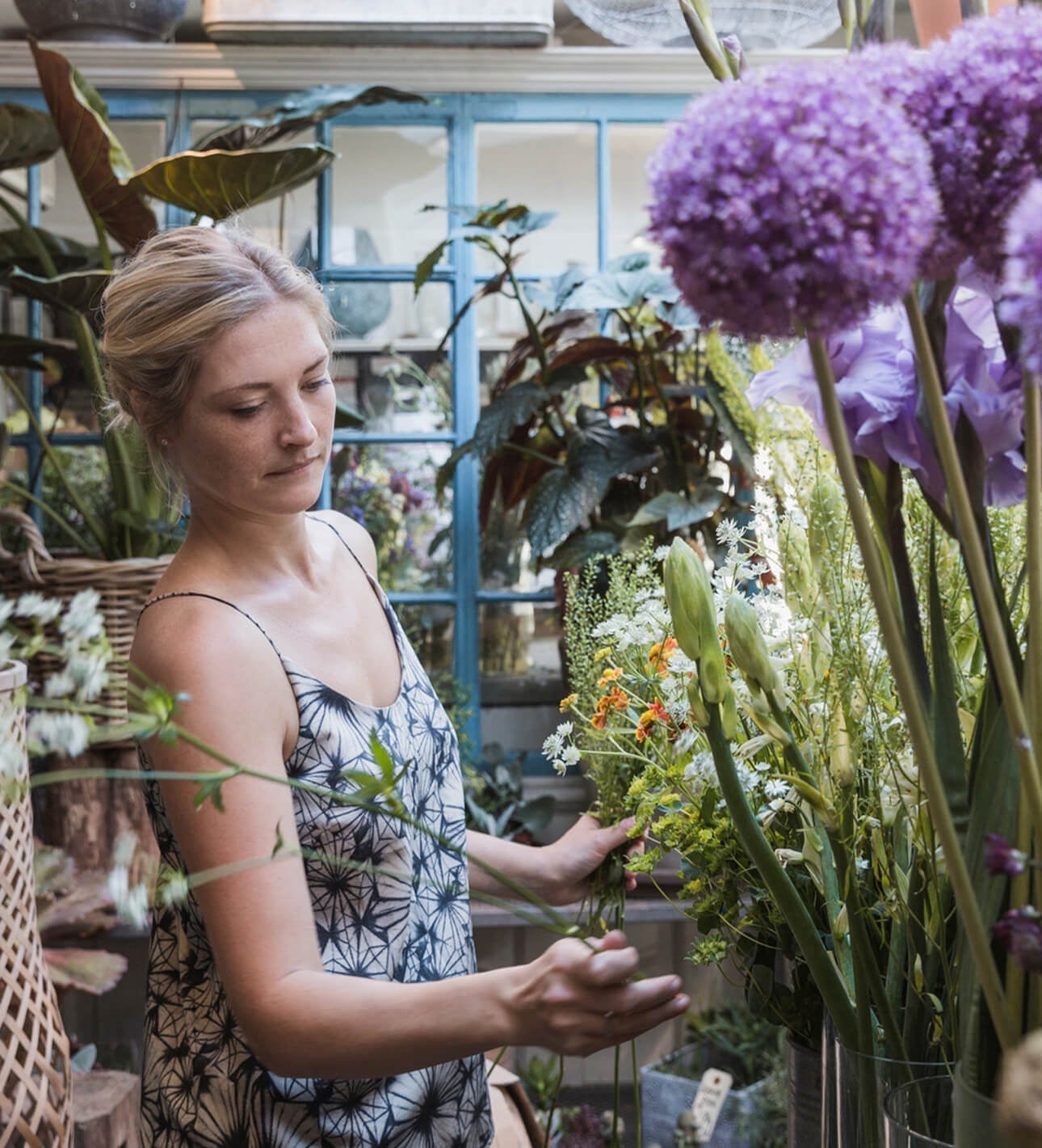 A woman works in her local flower shop