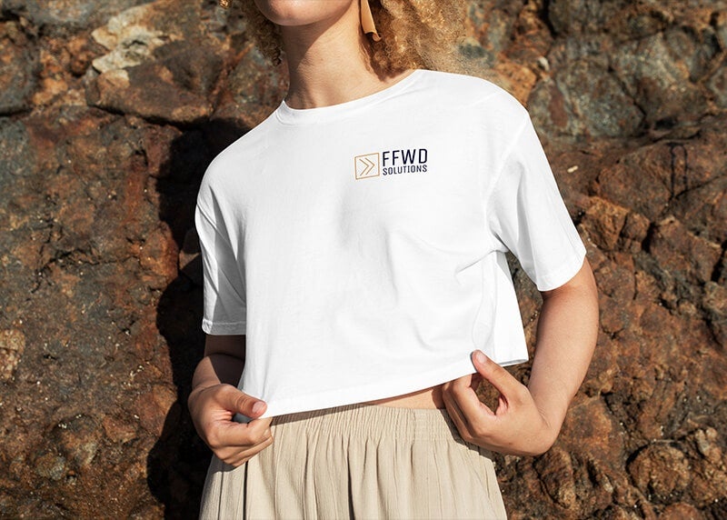 A person wearing a white tshirt with their FFWD Solutions business logo printed on it 