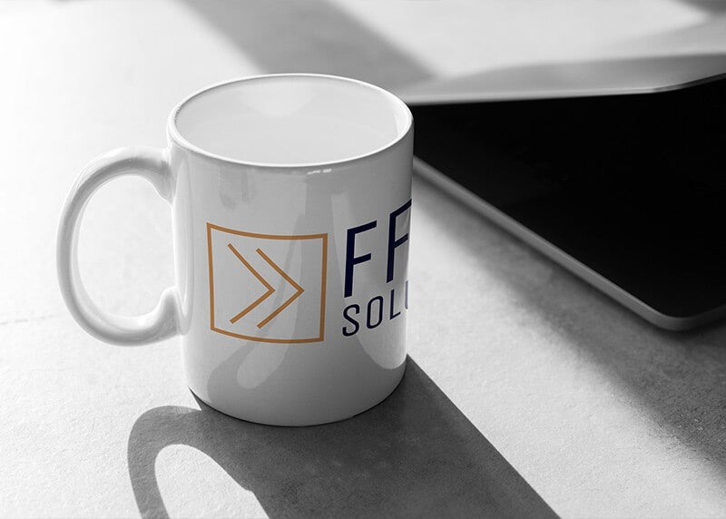 A mug with the FFWD Solutions logo printed on it in orange and white to match their brand identity
